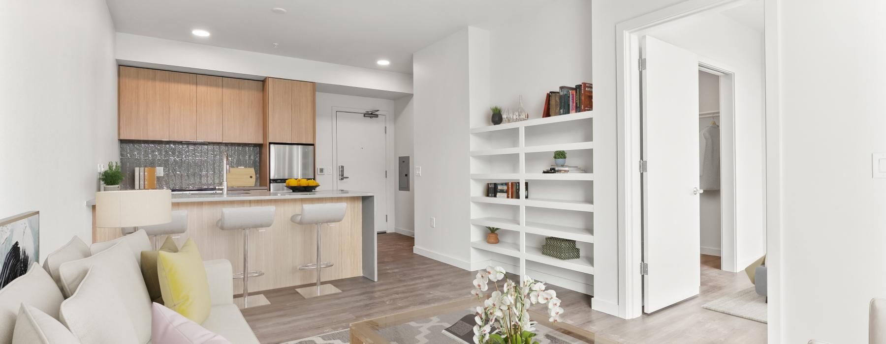a living room with a large kitchen