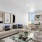 a living room with windows a couch and a coffee table